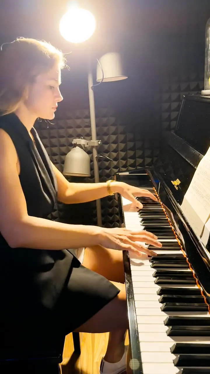 Marina Malina preparing music at the piano